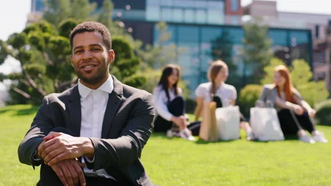Good looking office worker man black looking he posing in front of the camera Stock Footage 164862868