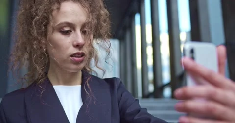 Good-looking office worker talking to a collegue, friend via a video face chat Stock Footage 137161426