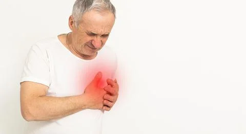 Good looking old man having chest pain heart attack or cardiac arrest with red Fotos de archivo