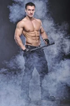 Good looking policeman bodybuilder posing Stock Photos