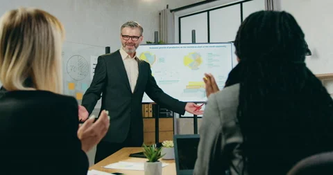 Good-looking positive experienced bearded coach leader ended his presentation Stock Footage 161077882