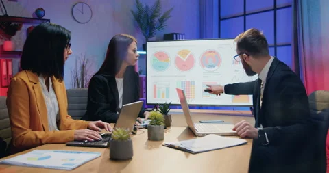 Good-looking purposeful motivated skilled businesspeople holding joint meeting Stock Footage 169762116