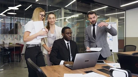 Good-looking satisfied multiethnic group of business people discussing together Stock Footage 124658201