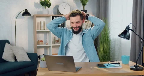 Good-looking satisfied skilled bearded guy sitting in relaxed pose in the chair Stock Footage 152777825