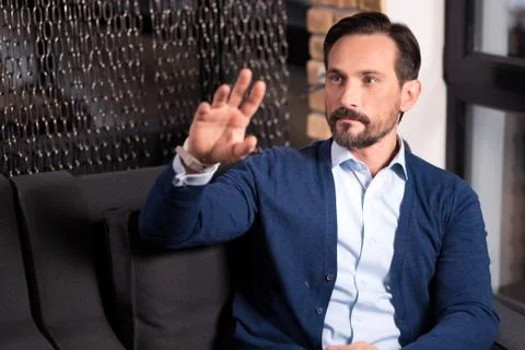 Good looking serious man using the latest technological developments Stock Photos