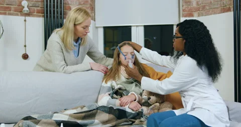 Good-looking skilled black-skinned female doctor helping caring mother to put on Stock Footage 144690399