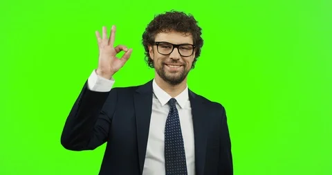 Good looking smiled man in glasses, suit and tie doing ok gesture with fingers Video stock 90730697