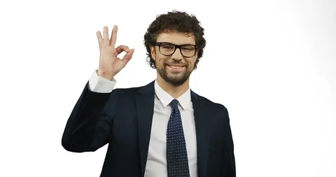 Good looking smiled man in glasses, suit and tie doing ok gesture with fingers Stock Footage 104288267