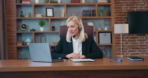 Good-looking smiling confident successful businesswoman with headset holding Stock Footage 203515385