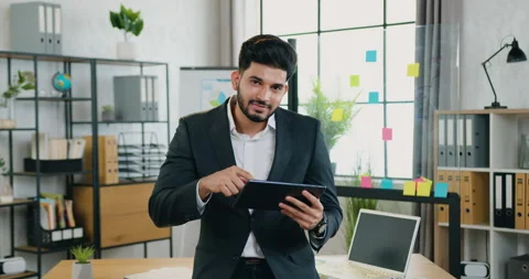 Good-looking smiling hardworking smart bearded young businessman in suit Stock Footage 159721305