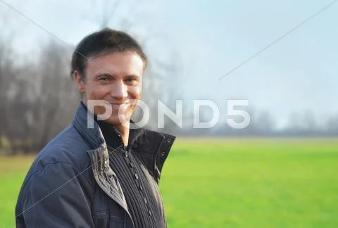 Good looking smiling man outdoors Stock Photos