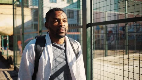 Good-looking student getting mobile phone from pocket. Cute surprised young Video stock 92054258