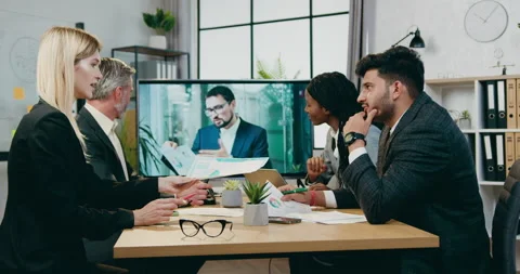 Good-looking successful experienced mixed race businesspeople have online Stock Footage 160988590