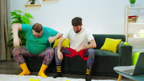 Good looking two friends while stay at home doing exercises to loose the weight Stock Footage 152412704