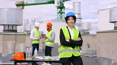 Good looking woman engineer assistant looking straight to the camera and smiling Stock Footage 145217242