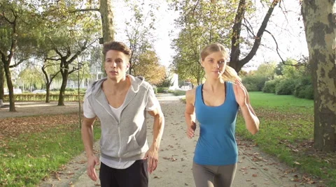 Good-Looking Young Couple Ends Up Their Jogging With High Five Stock Footage 42161149