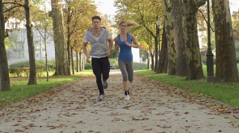 Good-Looking Young Couple Jogging After Work Stock Footage 42162399