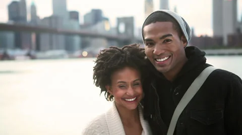 A good looking young couple stand together smiling and looking at the camera Stock Footage 33999161