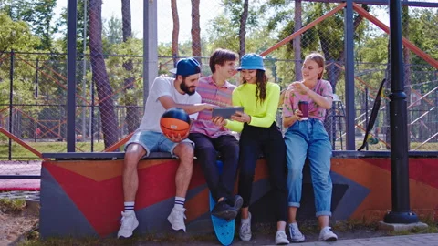 Good looking young group of stylish friends enjoying the time together in the Stock Footage 134409798