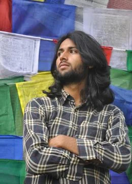 A good looking young guy looking sideways posing with his arms crossed Stock Photos