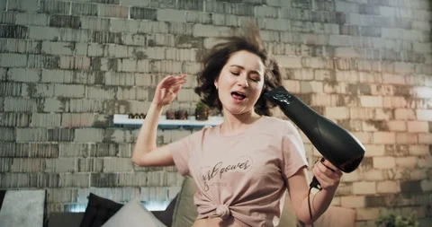 Good looking young lady have a fun time in the morning get ready drying her hair Stock-Footage 107791407