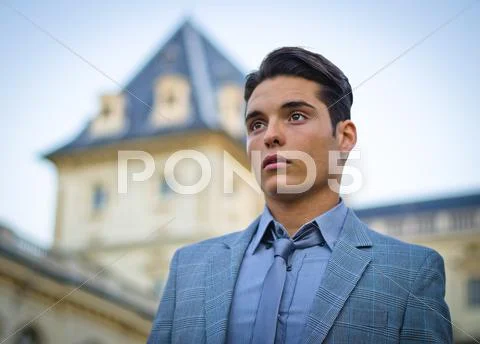 Good looking young man and elegant palace Stock Photos