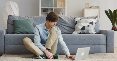 Good looking young man in the casual style using the laptop computer and Stock Footage 86888726