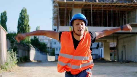 Good looking young worker at construction site with a safety equipment dancing Stock Footage 141185674