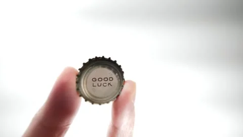 Good Luck printed on a bottle cap coming into view Stock Footage 255105741