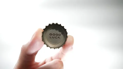 Good Luck printed on a bottle cap coming into view Stock Footage 255105794