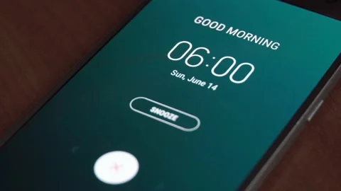 Good morning 6 am alarm clock on the phone, a finger taps snooze. Stock Footage