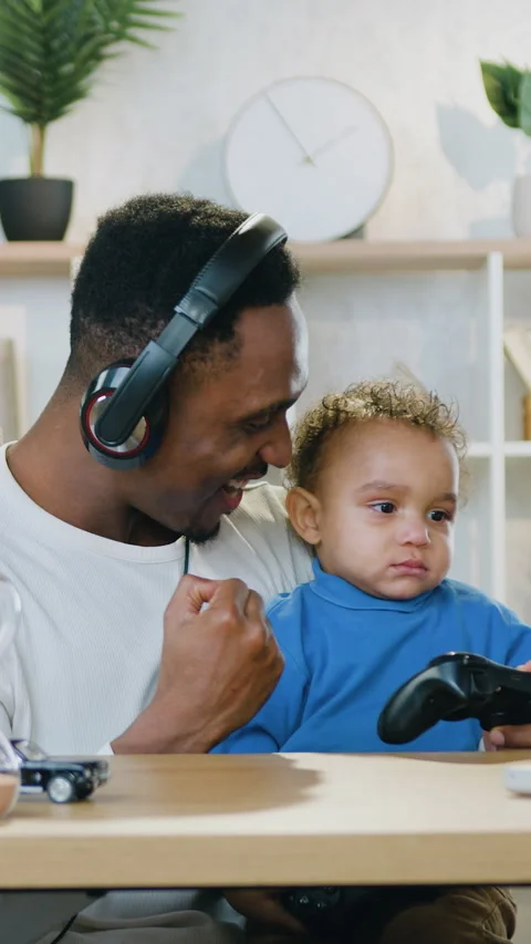 Good-natured cheerful caring 30-aged african american father in headset staying  Stock Footage 329436971
