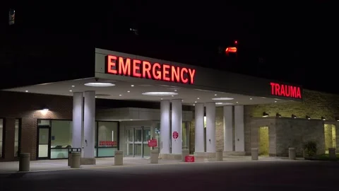 Good night establishing shot of a generic modern hospital with emergency room Stock Footage 164450195