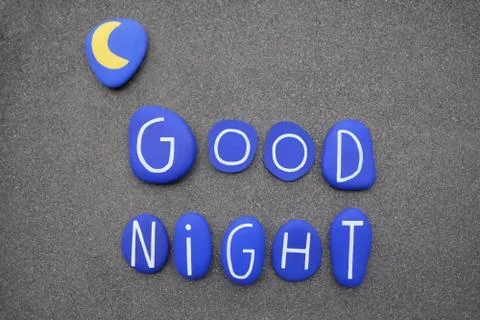 Good night text composed with blue colored stone letters over volcanic sand Stock Photos