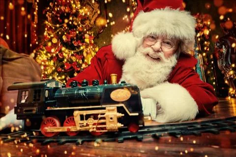 Good old Santa Claus brought gifts for Christmas and sat down to play a steam Stock Photos