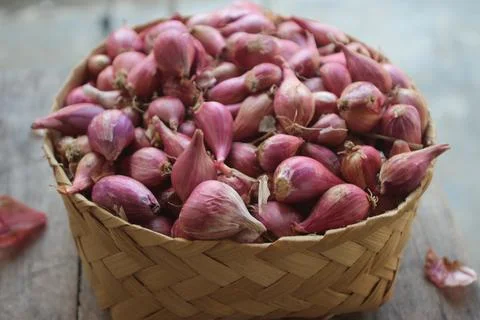 Good quality shallots and red onions in Indonesia for cooking in bamboo baske Stock Photos