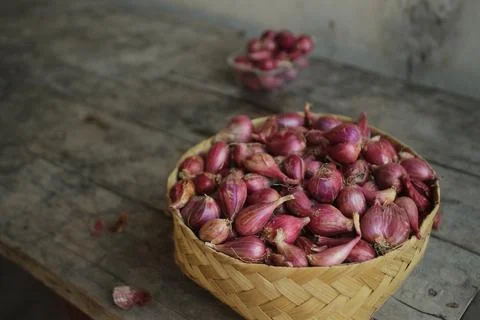 Good quality shallots and red onions in Indonesia for cooking in bamboo baske Stock Photos