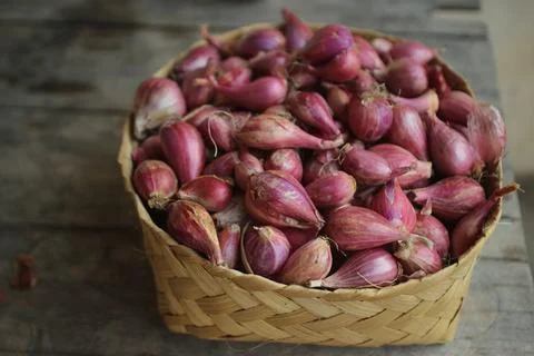 Good quality shallots and red onions in Indonesia for cooking in bamboo baske Stock Photos