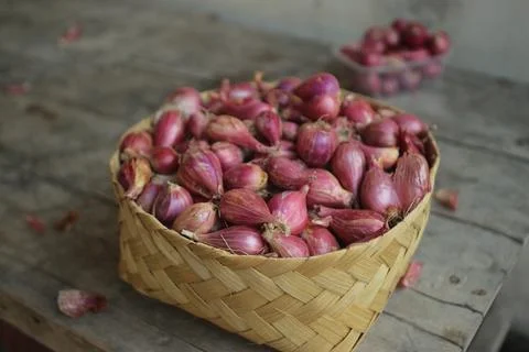 Good quality shallots and red onions in Indonesia for cooking in bamboo baske Stock Photos