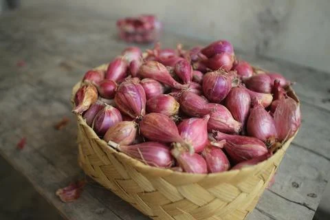 Good quality shallots and red onions in Indonesia for cooking in bamboo baske Stock Photos