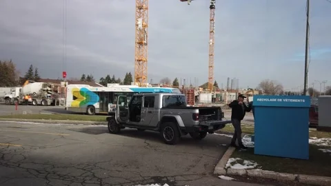 Good Samaritan donates clothes via bin Stock Footage 229953215