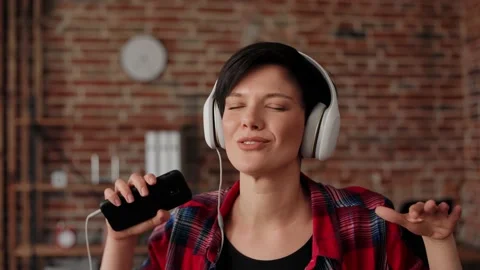 Good start to the day. Happy young woman in white headphones enjoy listening Stock Footage 164969733