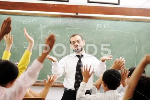 Good teacher in classroom in front of the board Stock Photos