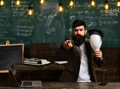Good teachers help students ask great questions. Hipster is solving math exam Stock Photos
