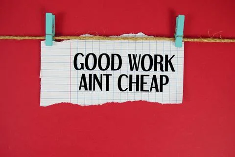 Good Work Aren't Cheap text written on rip paper with wooden clip on red ba.. Stockfoto's