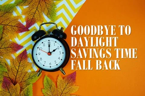 Goodbye To Daylight Savings Time Fall Back with alarm clock and maple leaf .. Stock Photos