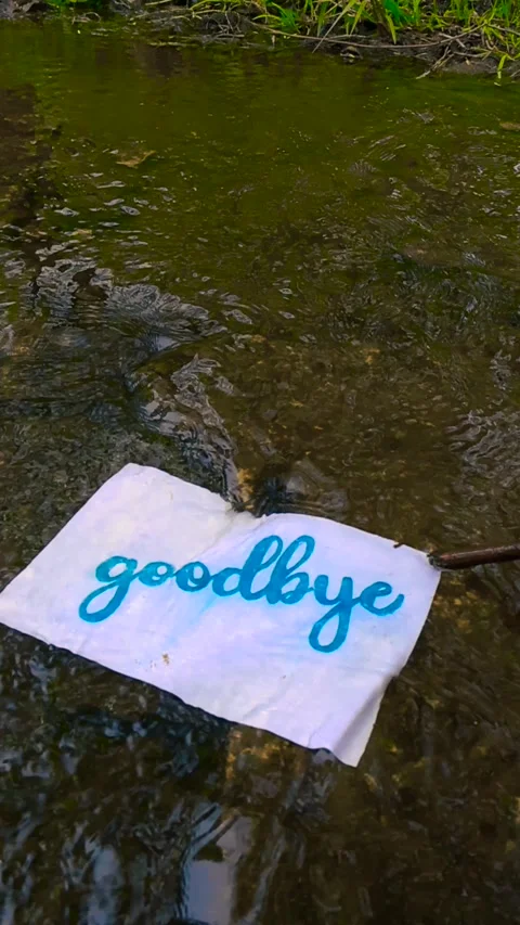 Goodbye Letter Floating Away in a Shallow River Current Stock Footage 336650876