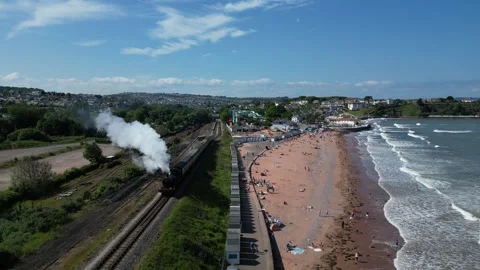 Goodrington, Devon, England: DRONE VIEWS: Steam train on route to Kingswear Stock Footage 242615645