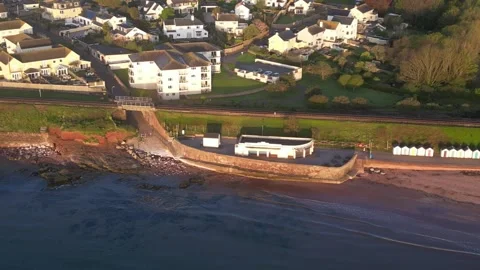 Goodrington Sands, Devon, England: DRONE VIEWS: Cafe, beach huts &amp; railway track Stock Footage 240096521