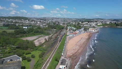 Goodrington Sands, Devon, England: DRONE VIEWS: Steam train on route to Paignton Stock Footage 241140856